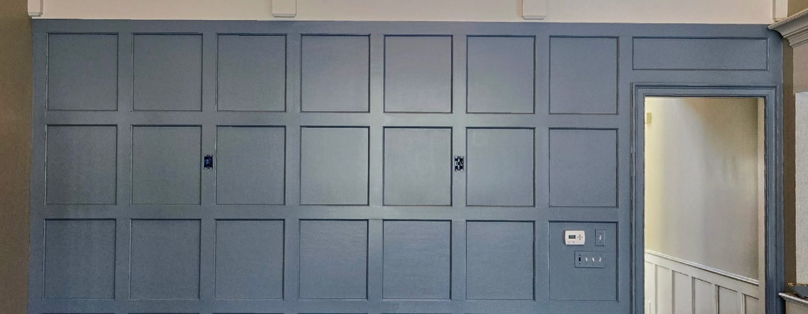 Slate blue custom wall paneling with decorative molding and crown trim in a New Canaan, CT home