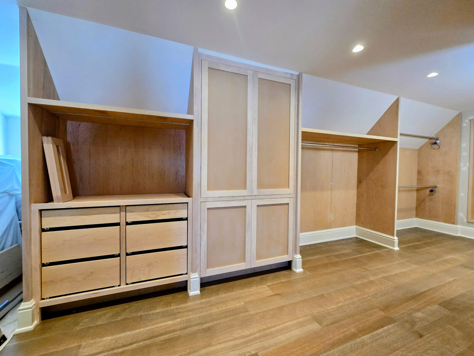 Custom walk-in closet under construction in Ridgefield Connecticut with custom drawers and hanging areas in unfinished wood