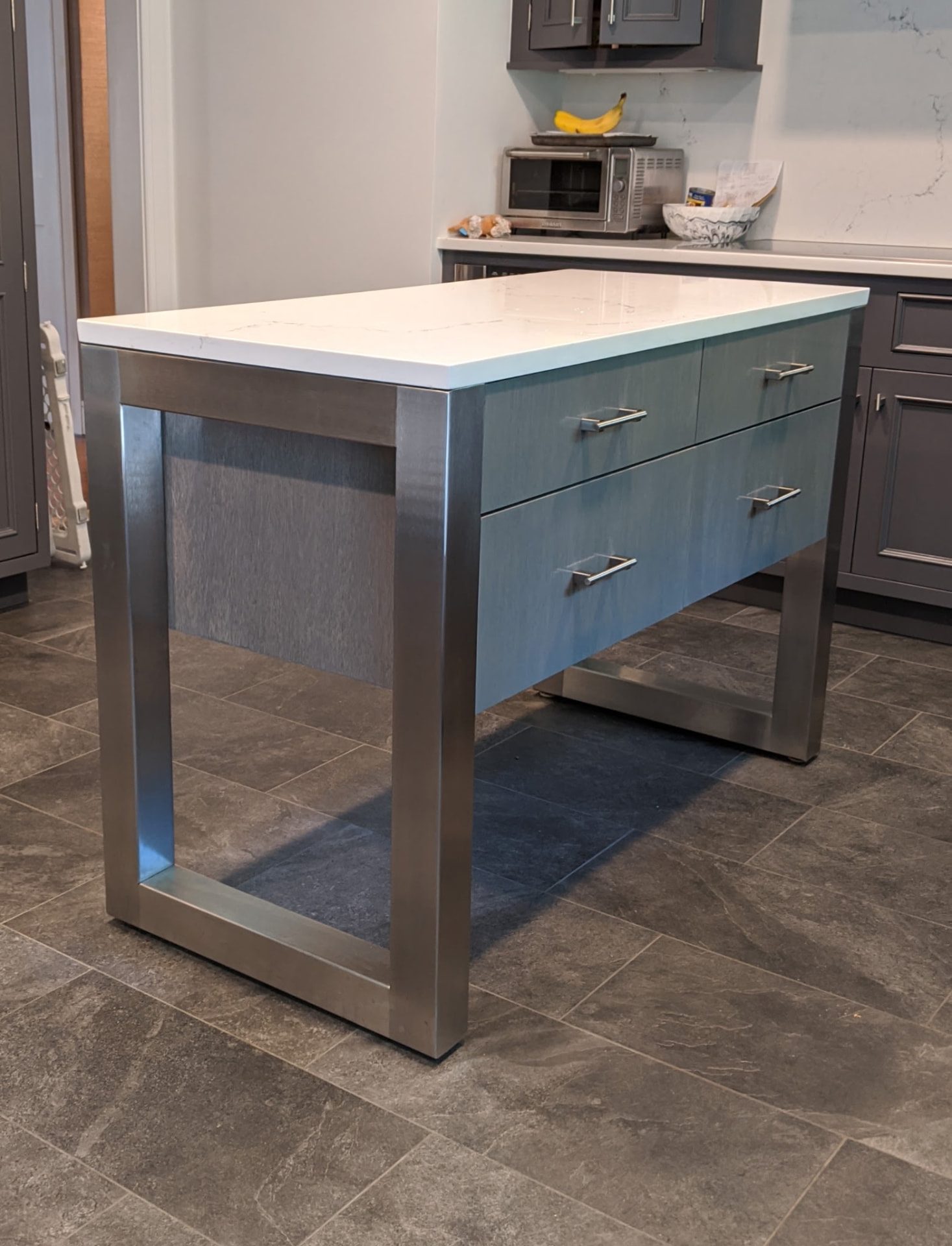 Kitchen island with blue-gray storage drawers and metal framing in Ridgefield, CT.